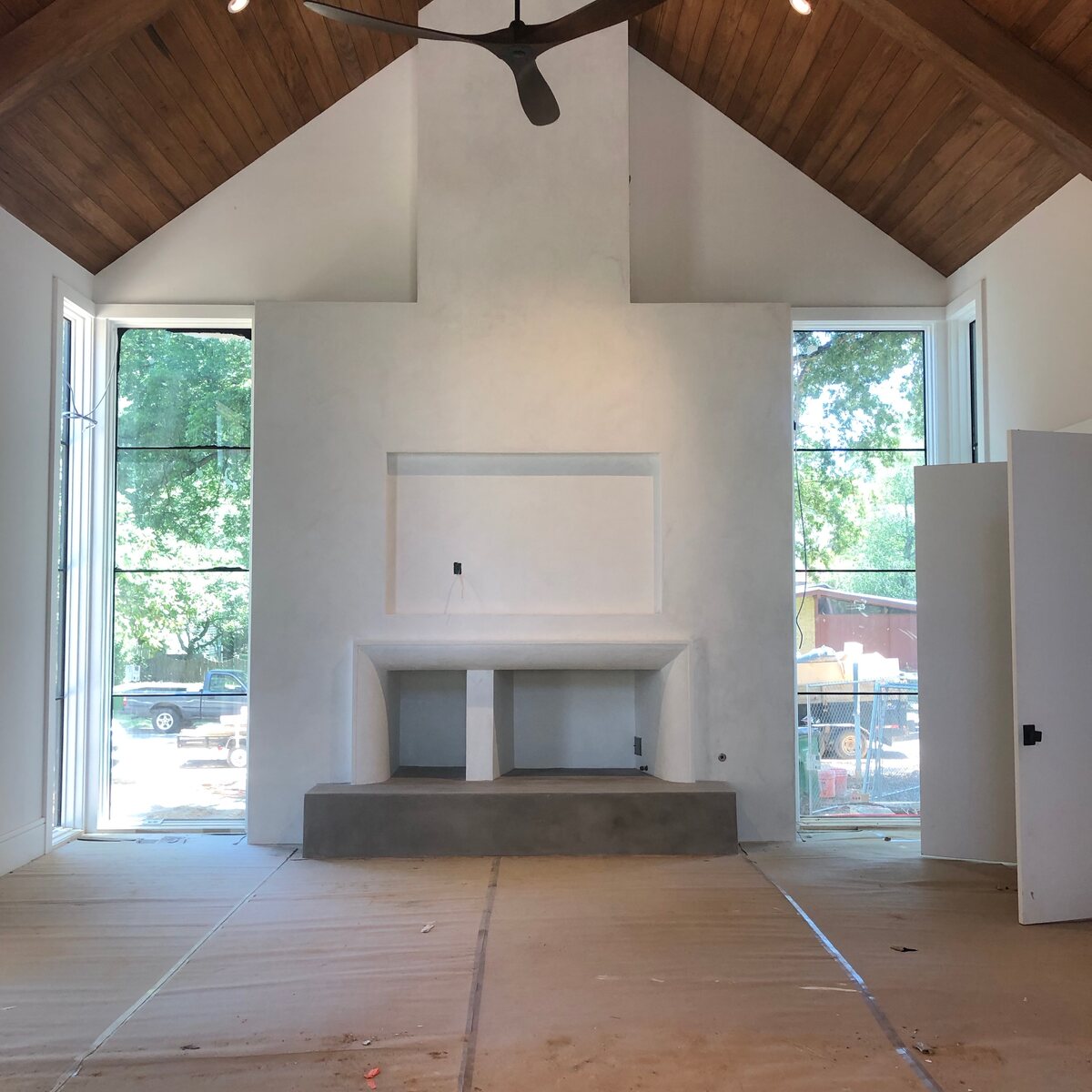 Vaulted great room with plaster fireplace